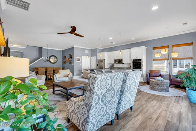 a kitchen with stainless steel appliances granite countertop a sink refrigerator stove and microwave