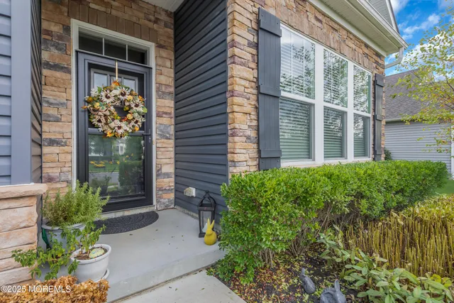 a bedroom with a bed and a lamp on dresser