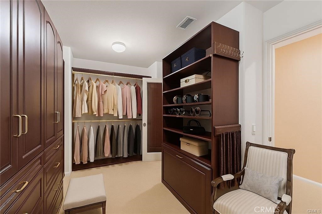 8634 Hunt Canyon Road Corona, CA 92883 - Photo 20 of 31 a view of walk in closet with clothes and shoes