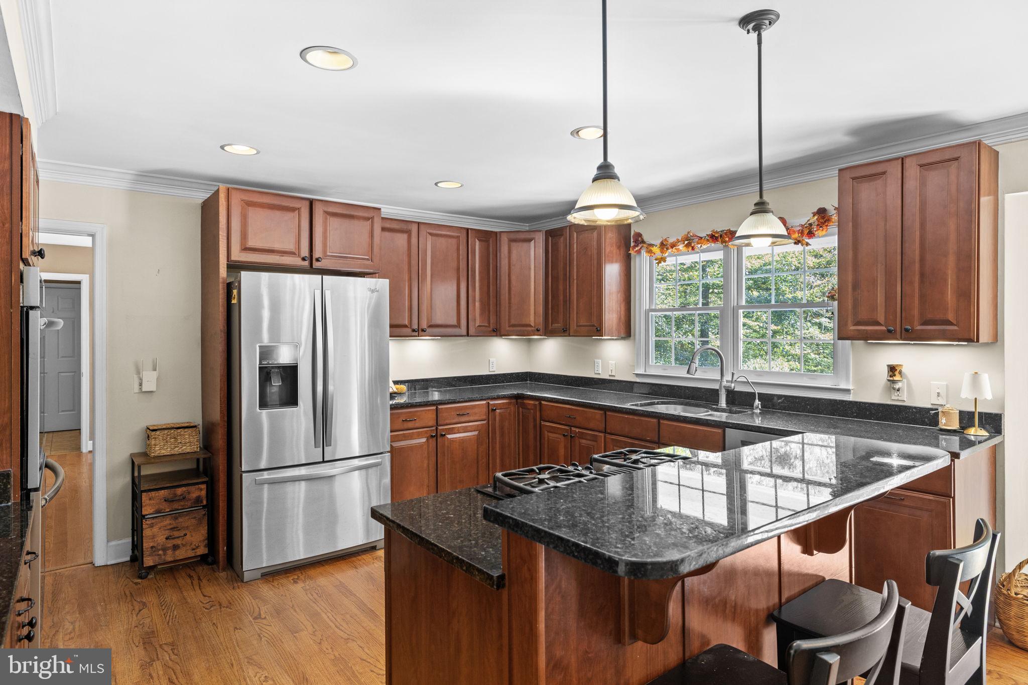 135 Old Cropps Mill Road Fredericksburg, VA 22406 - Photo 20 of 47 a kitchen with stainless steel appliances granite countertop a sink a refrigerator and a stove