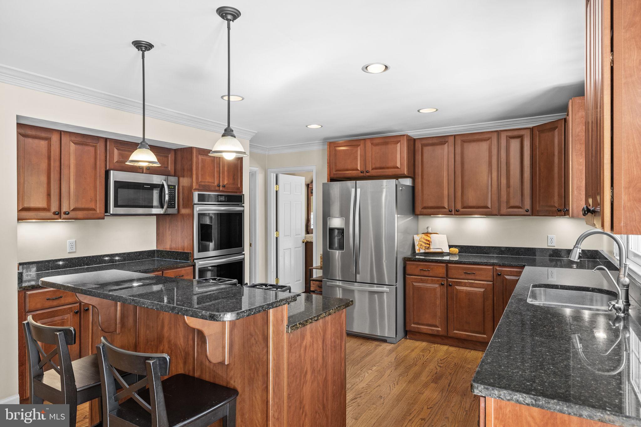135 Old Cropps Mill Road Fredericksburg, VA 22406 - Photo 21 of 47 a kitchen with stainless steel appliances granite countertop a stove a sink refrigerator and a microwave
