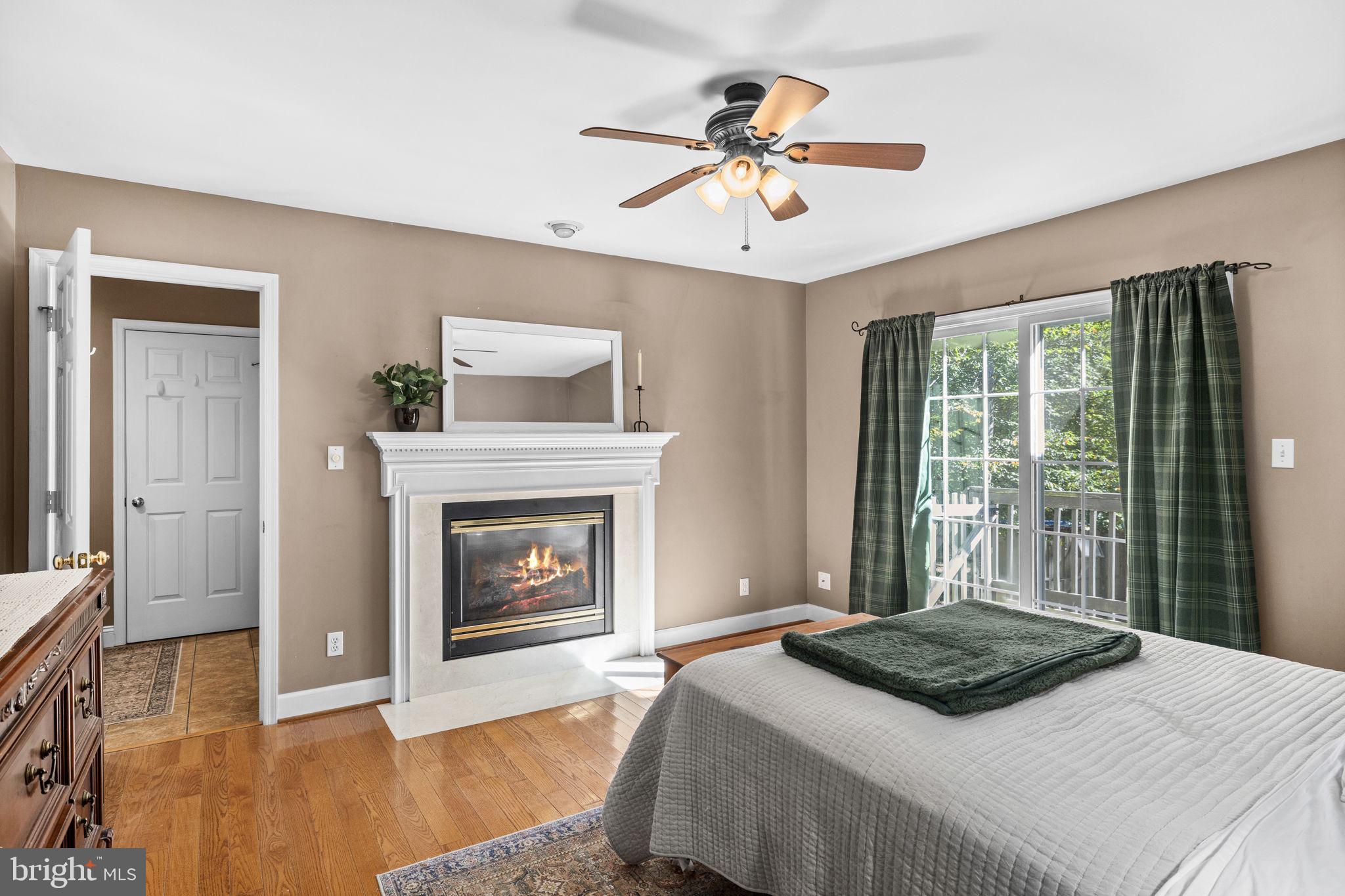 135 Old Cropps Mill Road Fredericksburg, VA 22406 - Photo 24 of 47 a bedroom with a bed and a fireplace