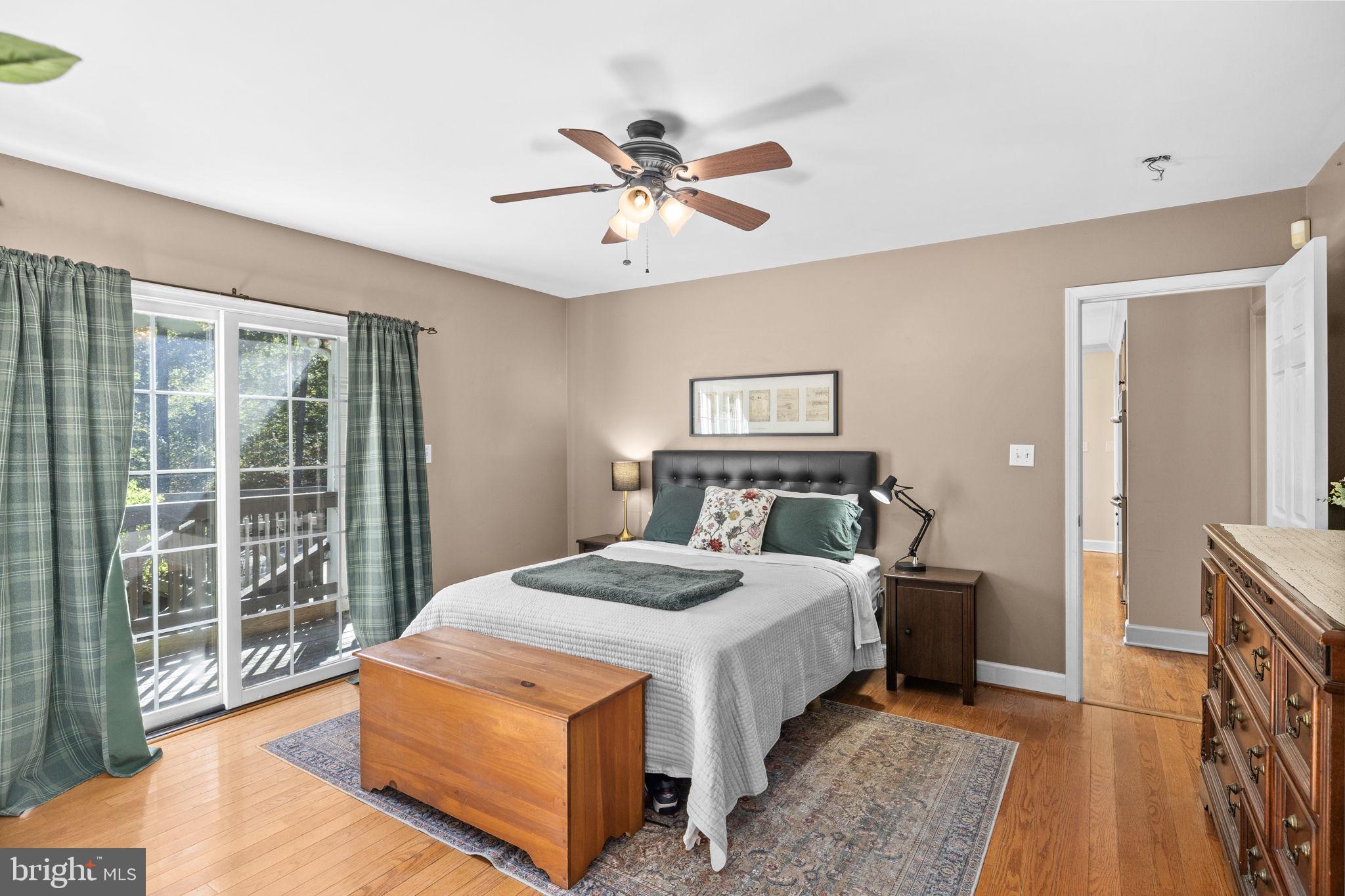 135 Old Cropps Mill Road Fredericksburg, VA 22406 - Photo 25 of 47 a bedroom with a large bed and a chandelier