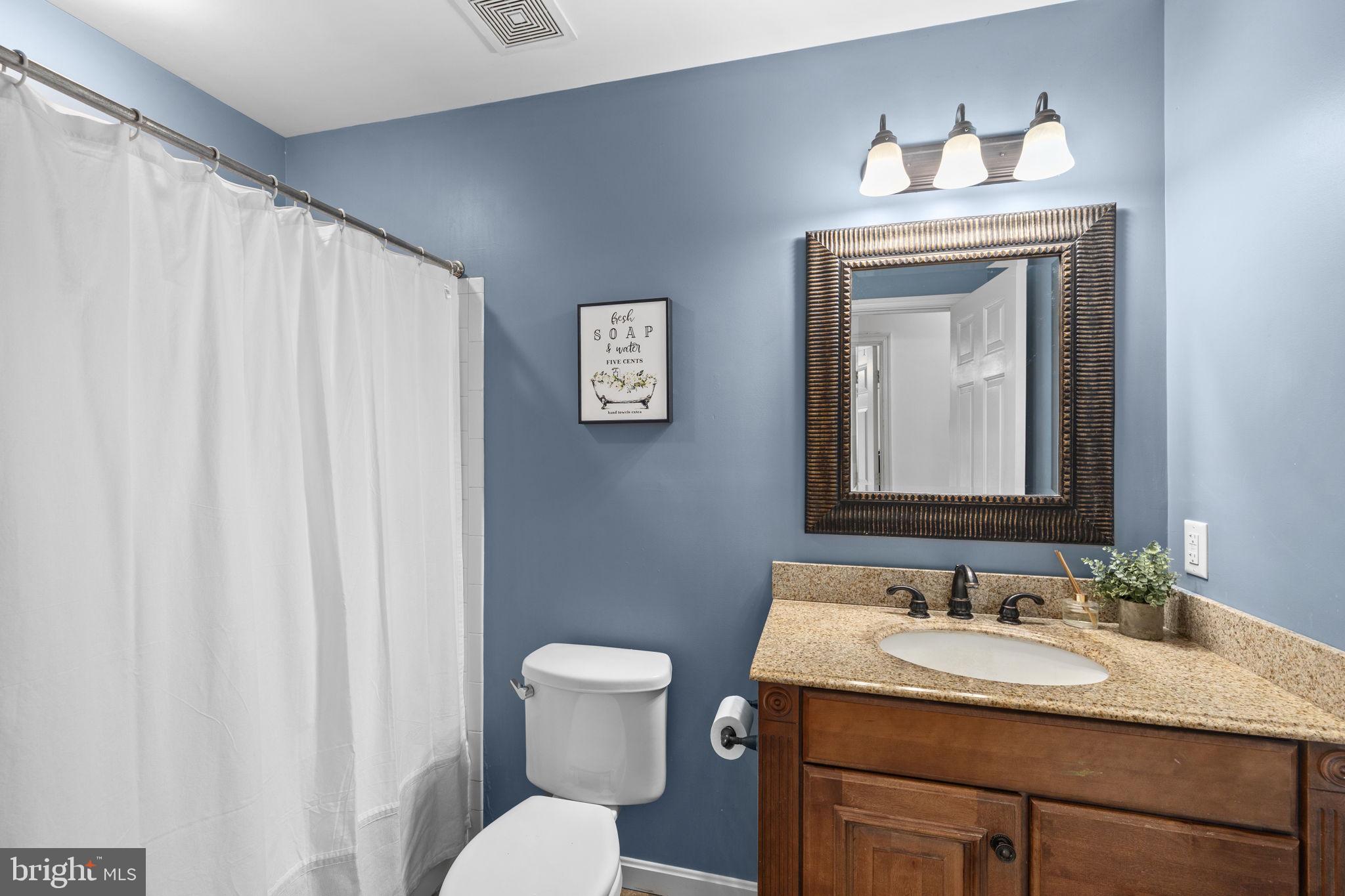 135 Old Cropps Mill Road Fredericksburg, VA 22406 - Photo 31 of 47 a bathroom with a granite countertop sink vanity mirror and toilet