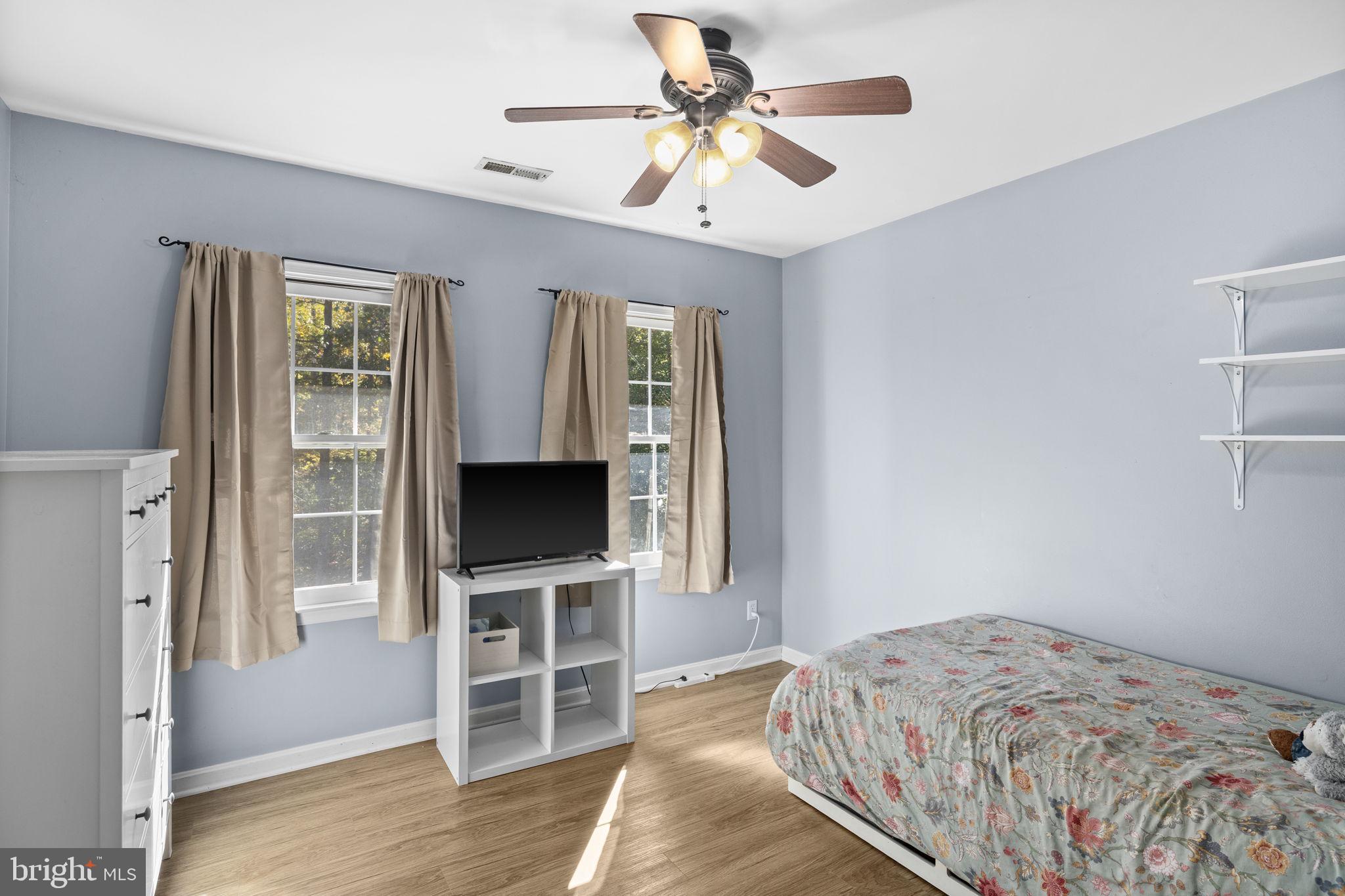 135 Old Cropps Mill Road Fredericksburg, VA 22406 - Photo 32 of 47 a bedroom with a bed and a flat screen tv