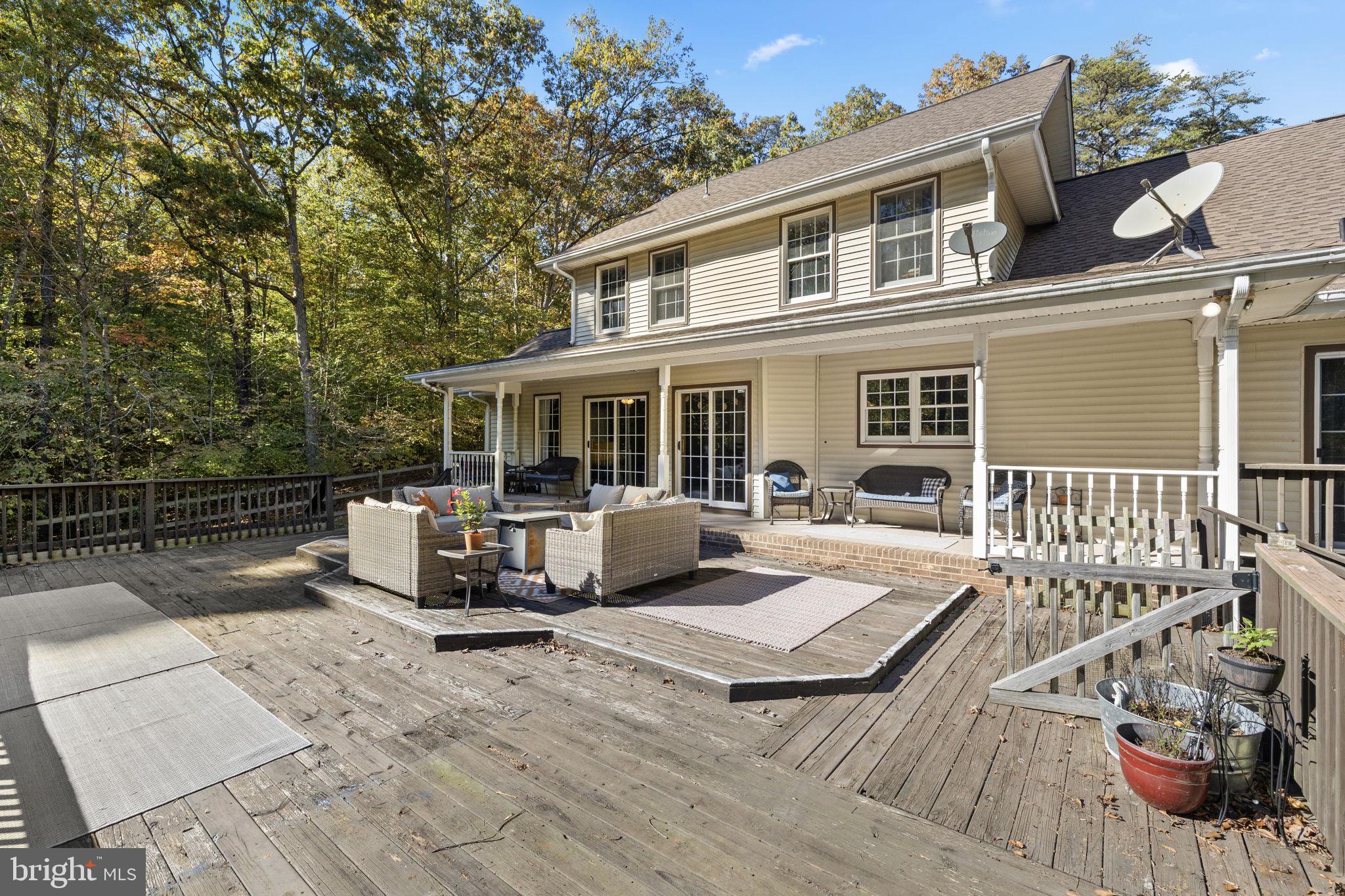135 Old Cropps Mill Road Fredericksburg, VA 22406 - Photo 38 of 47 a view of a house with wooden deck and furniture