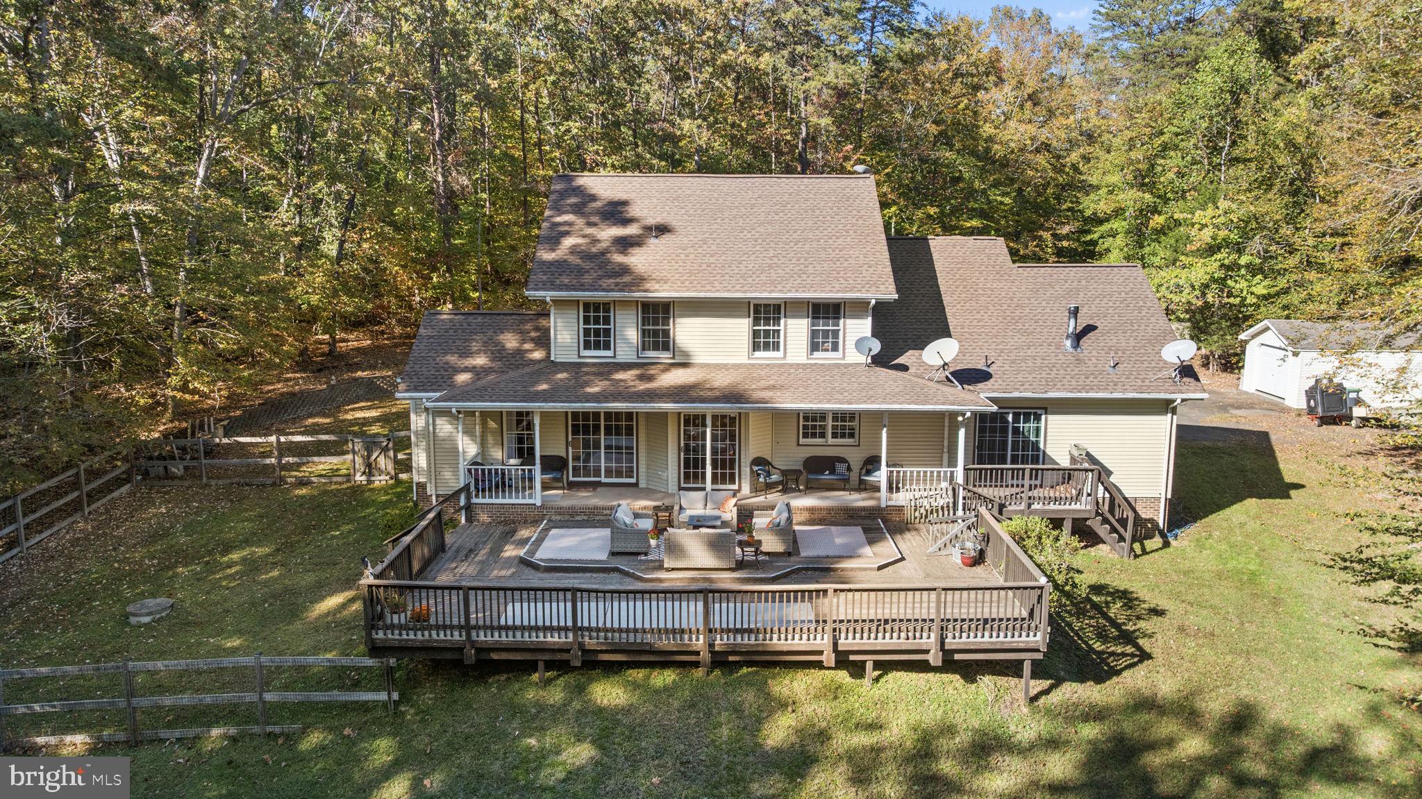 135 Old Cropps Mill Road Fredericksburg, VA 22406 - Photo 46 of 47 a front view of a house with a garden and swimming pool