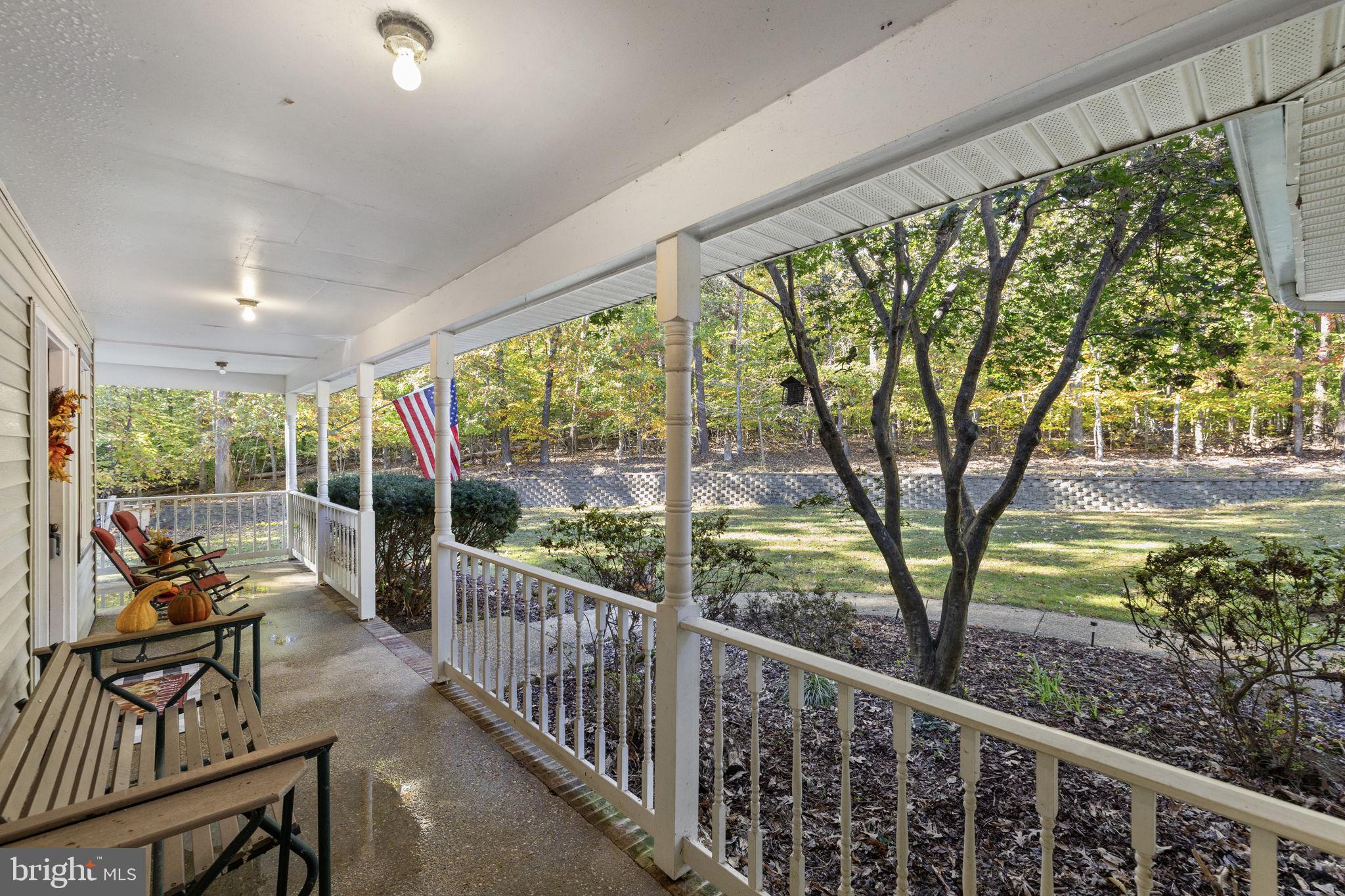 135 Old Cropps Mill Road Fredericksburg, VA 22406 - Photo 5 of 47 a view of a porch with furniture and garden