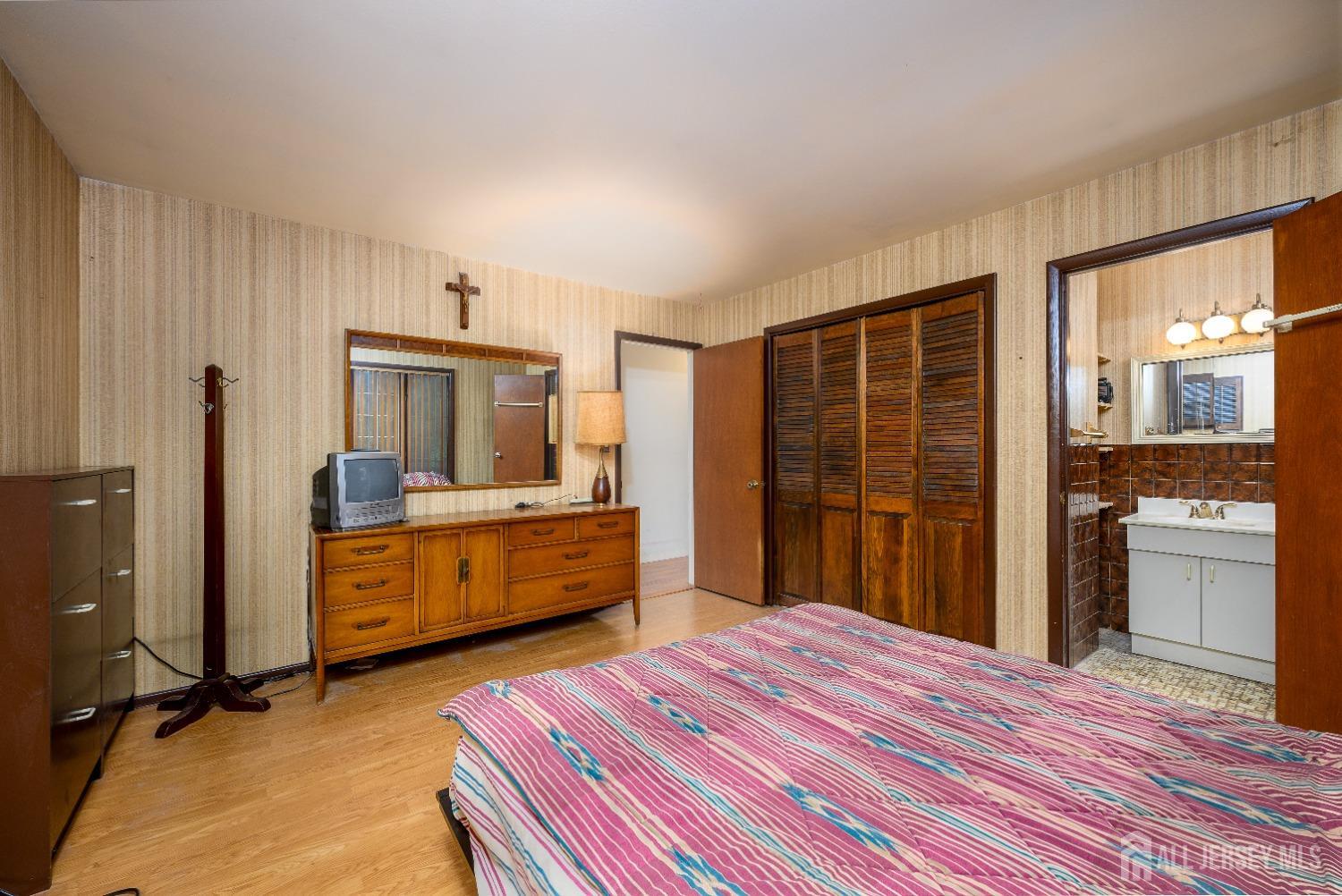 13 Brookside Road Edison, NJ 08817 - Photo 18 of 32 a bedroom with a bed and wooden floor