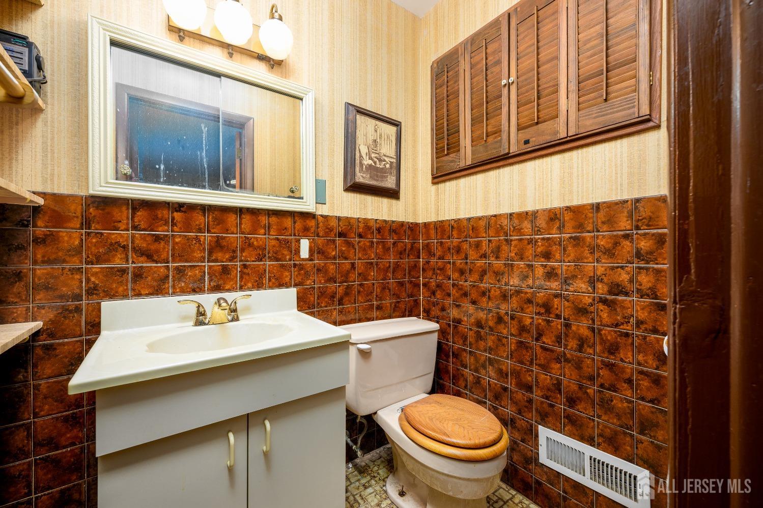 13 Brookside Road Edison, NJ 08817 - Photo 19 of 32 a bathroom with a sink a toilet and a mirror
