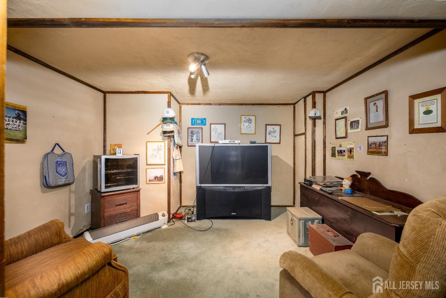 13 Brookside Road Edison, NJ 08817 - Photo 25 of 32 a living room with furniture and a flat screen tv