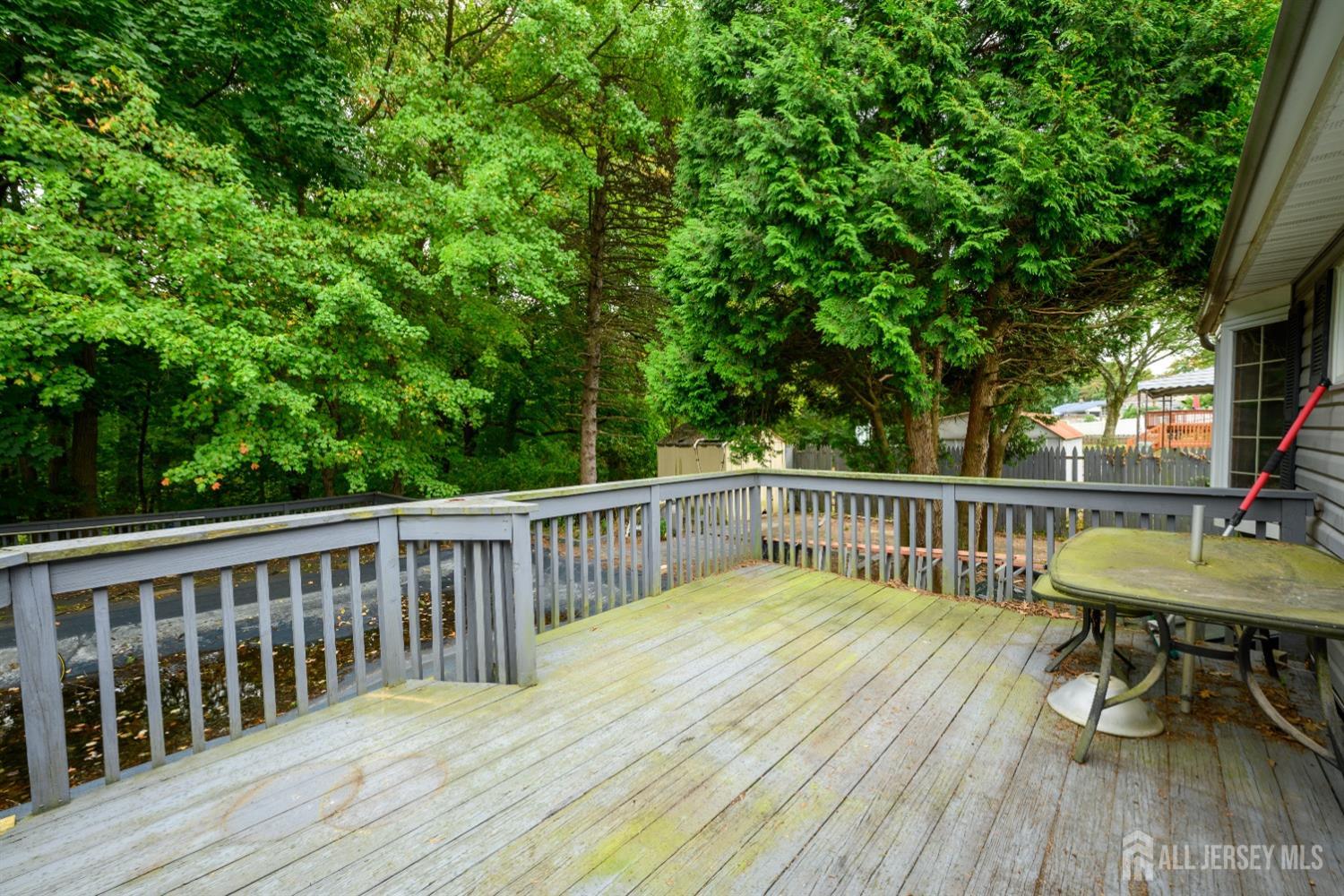 13 Brookside Road Edison, NJ 08817 - Photo 30 of 32 a view of a deck with furniture and trees