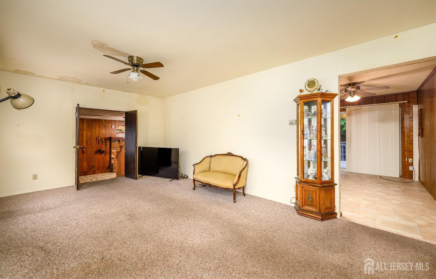 13 Brookside Road Edison, NJ 08817 - Photo 4 of 32 a view of a livingroom with a furniture and a ceiling fan