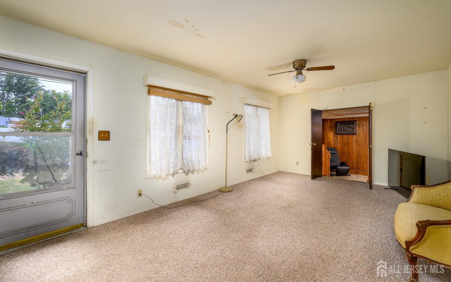 13 Brookside Road Edison, NJ 08817 - Photo 5 of 32 a view of an empty room with window and stairs