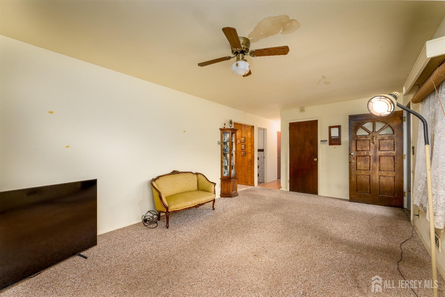 13 Brookside Road Edison, NJ 08817 - Photo 6 of 32 a view of a livingroom with a furniture and ceiling fan