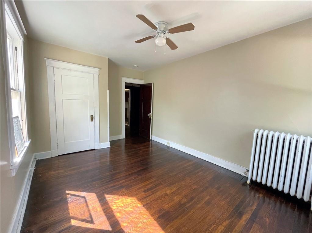 600 Ardmore Boulevard, Unit 2 Pittsburgh, PA 15221 - Photo 3 of 6 an empty room with wooden floor and a ceiling fan