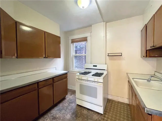 a kitchen with a sink stove and cabinets