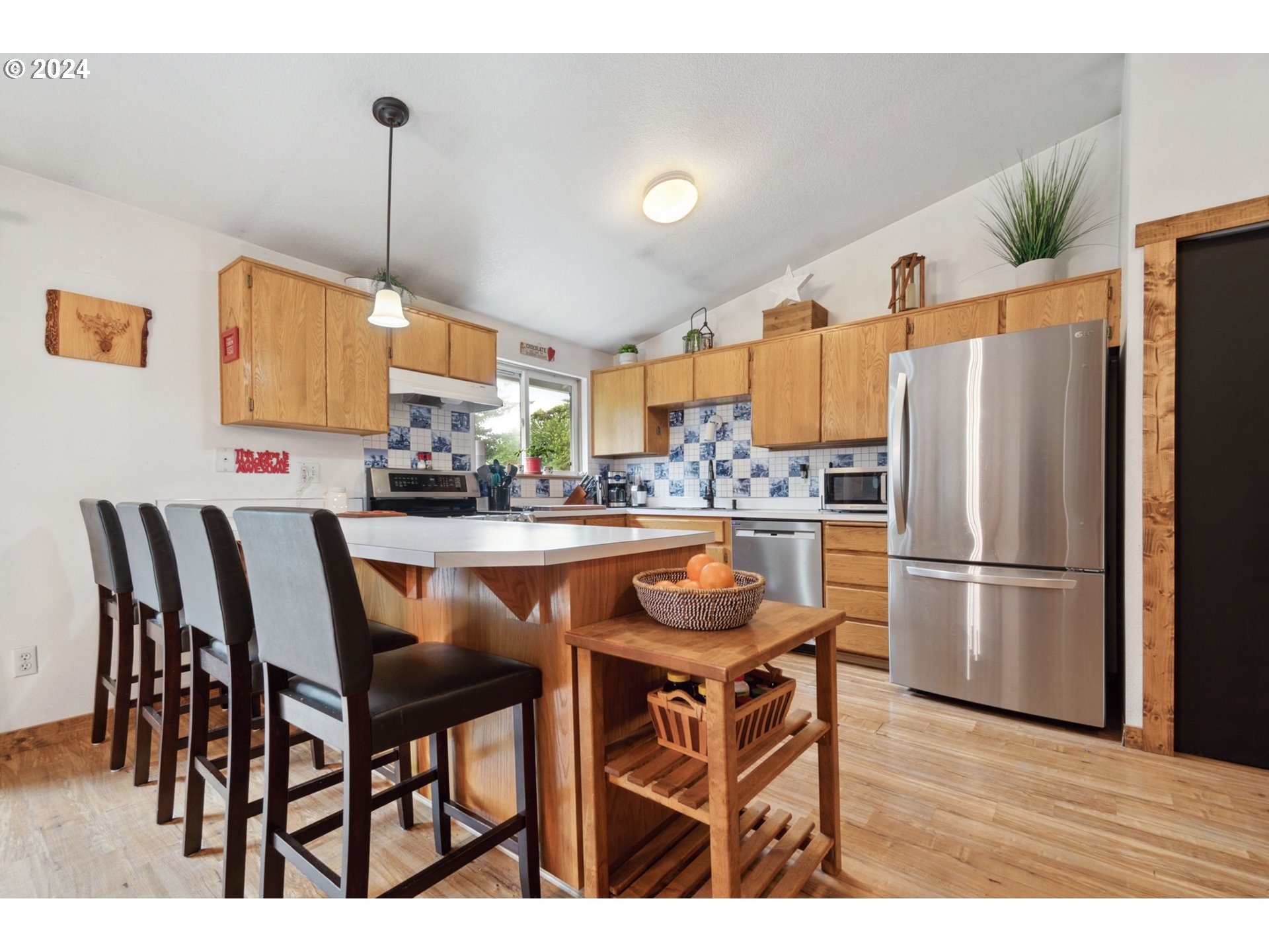 890 1st Falls View Road Stevenson, WA 98648 - Photo 15 of 43 a kitchen with stainless steel appliances a refrigerator a stove a dining table chairs and a oven