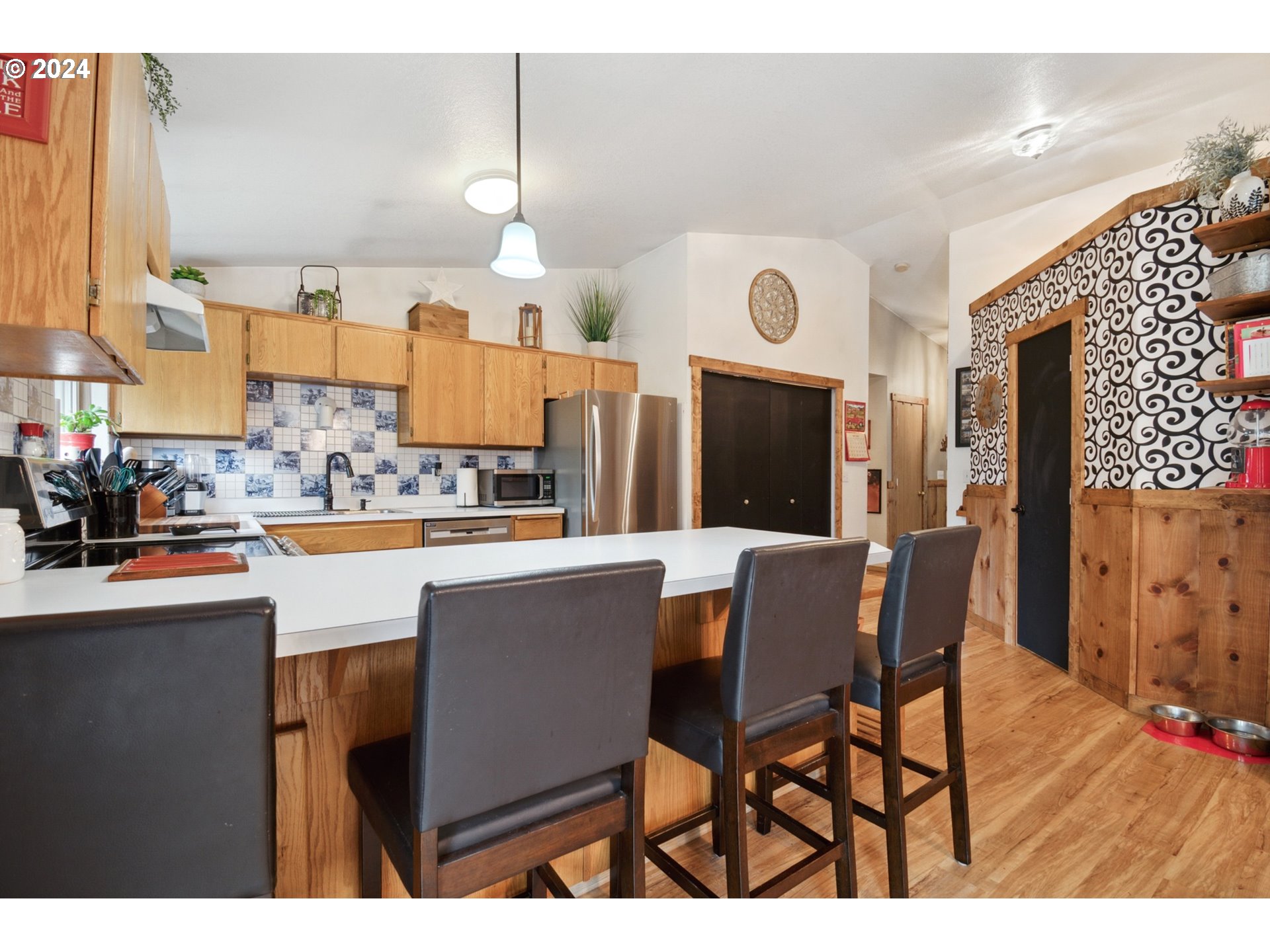 890 1st Falls View Road Stevenson, WA 98648 - Photo 16 of 43 a kitchen with stainless steel appliances granite countertop a table chairs and a refrigerator