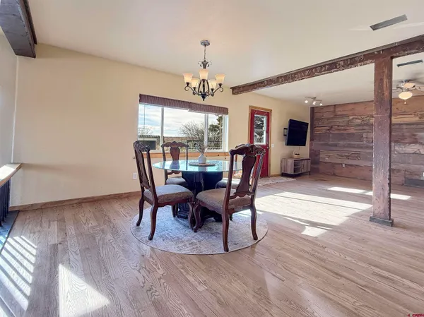 a living room with lots of furniture and wooden floor