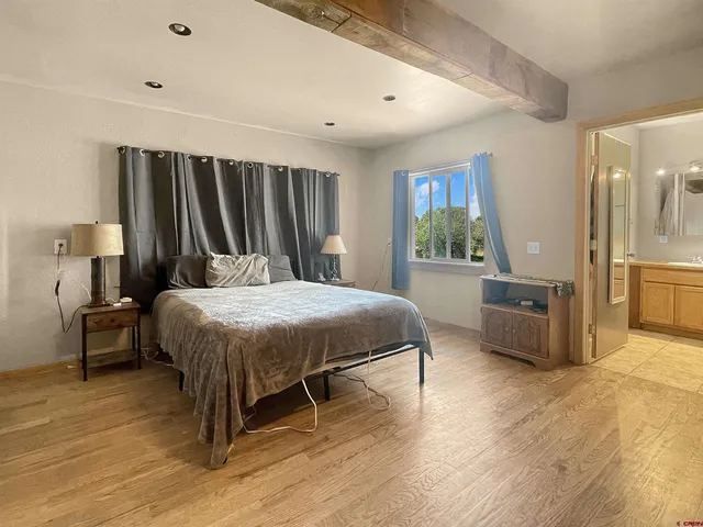 a bedroom with furniture and a flat screen tv