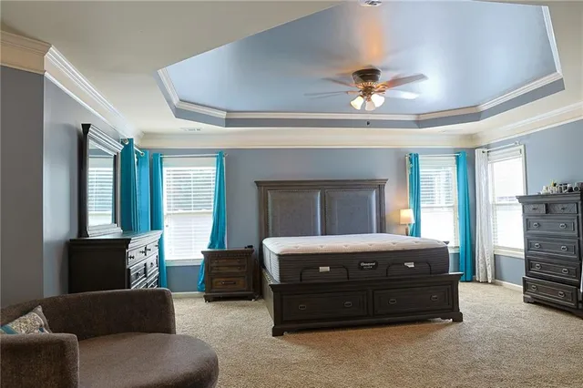 a bedroom with a bed dresser and a window