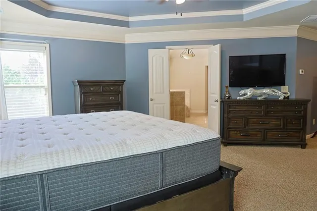 a bedroom with a bed and a flat screen television