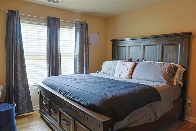 a bedroom with a bed and a window