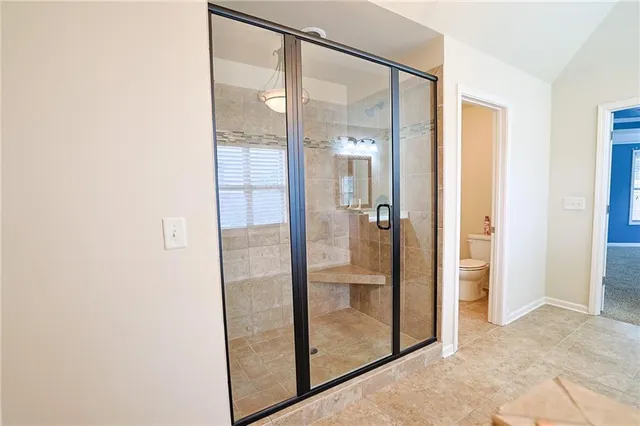 an empty room with a ceiling fan and a window