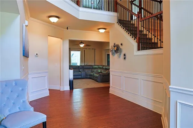 a hallway with wooden floor table and chairs