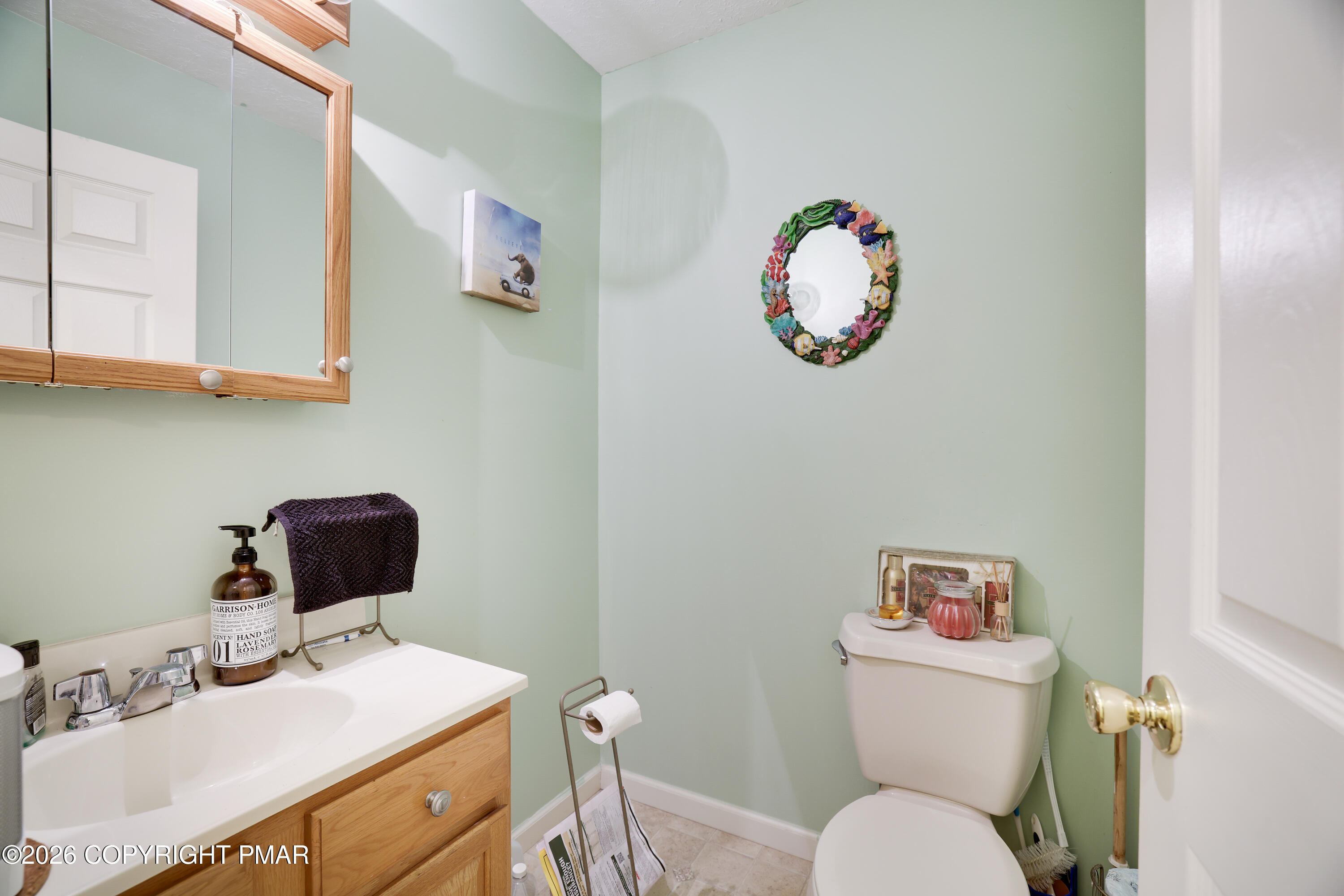 2137 Freedom Way Pocono Summit, PA 18346 - Photo 16 of 71 a bathroom with a toilet a sink and a mirror