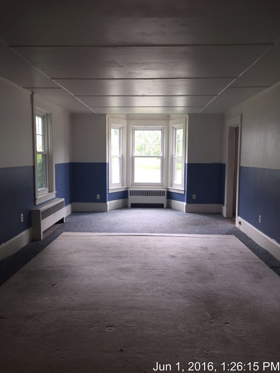 559 Turnpike Road New Ipswich, NH 03071 - Photo 13 of 22 an empty room with windows and fireplace