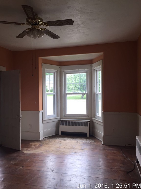 559 Turnpike Road New Ipswich, NH 03071 - Photo 5 of 22 an empty room with wooden floor and windows