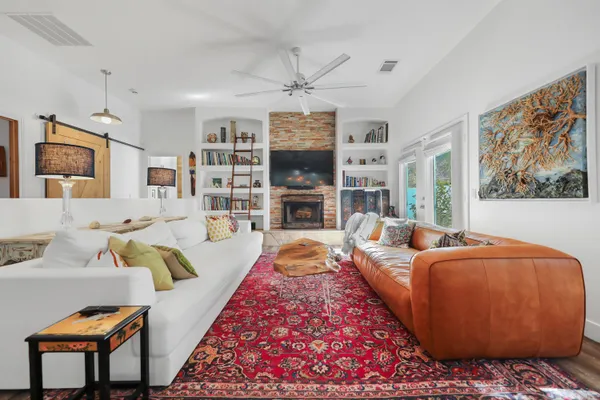 a living room with furniture fireplace and flat screen tv
