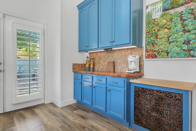 a kitchen with wooden cabinets and a window