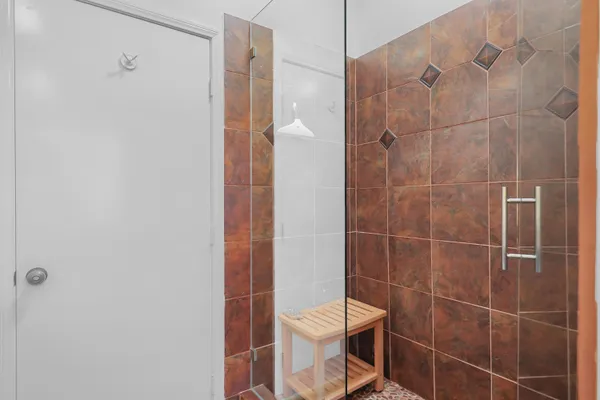 a bathroom with a toilet and a shower