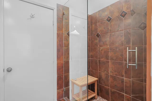 a bathroom with a toilet and a shower