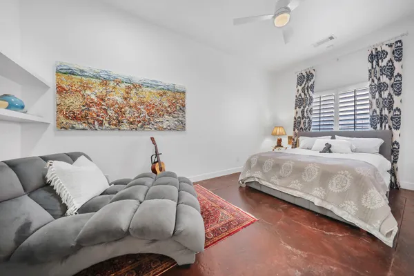 a bedroom with bed and window