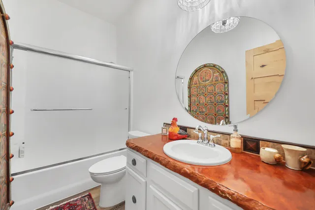 a bathroom with a sink a toilet and a mirror