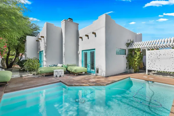 a view of backyard with outdoor seating and plants