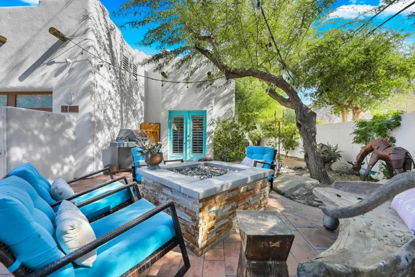 a view of a backyard with sitting area