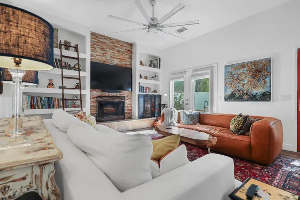 a living room with fireplace furniture and a flat screen tv