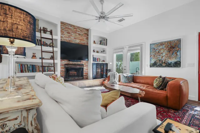 a living room with fireplace furniture and a flat screen tv