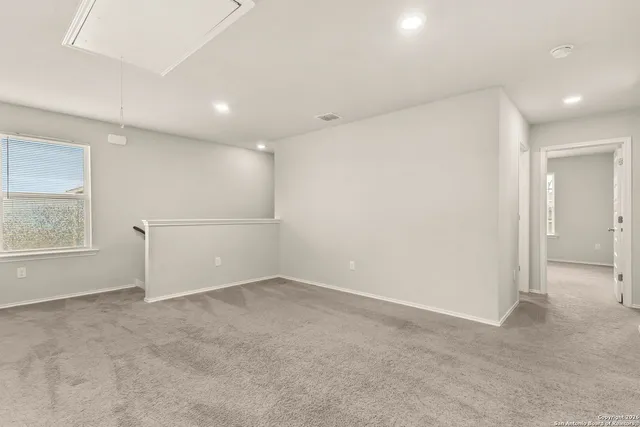 an empty room with windows and closet