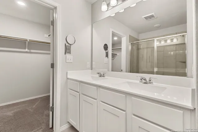 a bathroom with a glass shower door