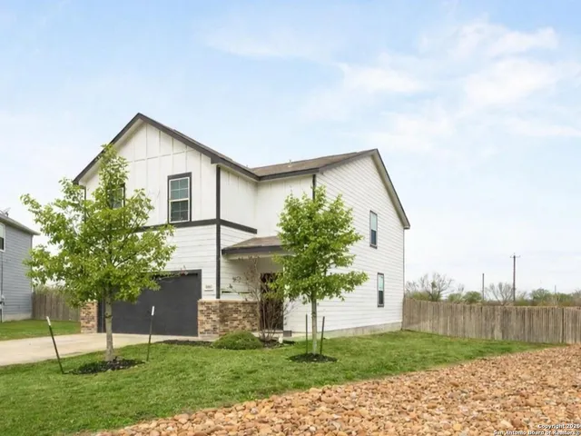 a view of a house with a yard and a garden