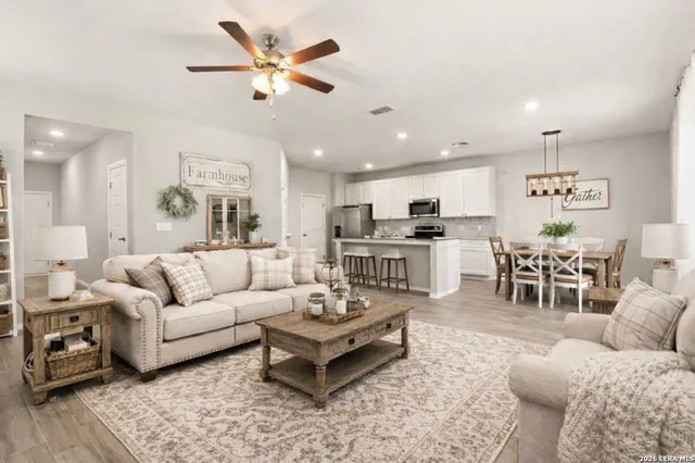 a living room with furniture and kitchen view