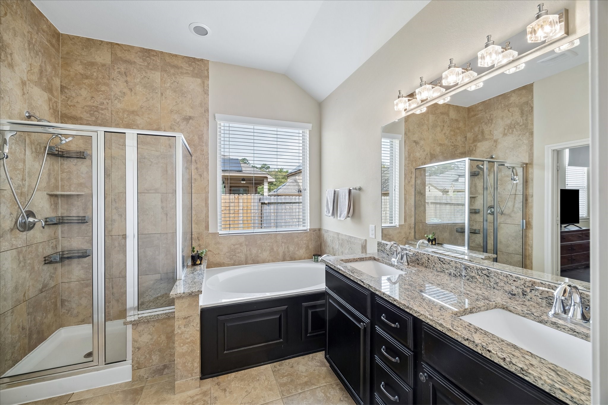 6723 Hunters Way Lane Baytown, TX 77521 - Photo 7 of 16 Primary bathroom featuring dual sinks with a separate soaking tub and a walk-in shower.