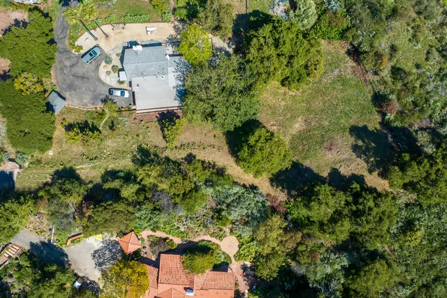 an aerial view of a house with a yard