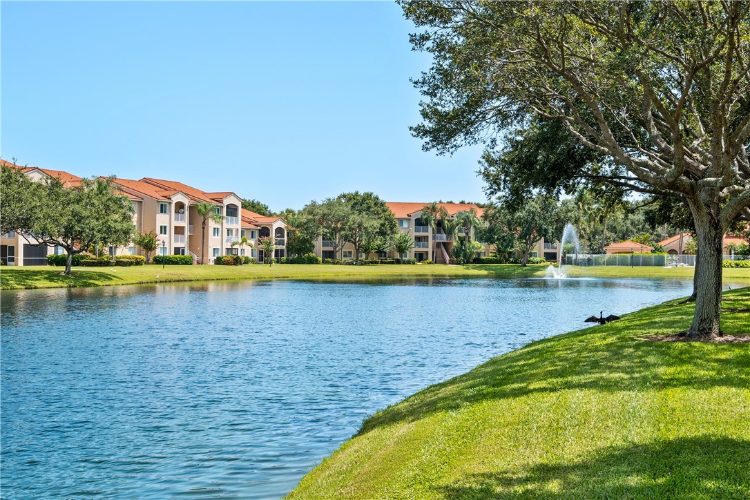 Undisclosed Address Vero Beach, FL 32967 - Photo 2 of 36 a view of a swimming pool in front of a house with a lake